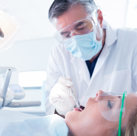 Dentist performing an oral exam