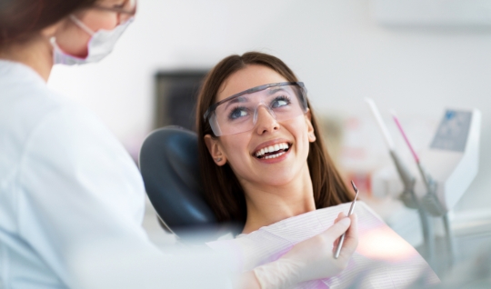 Patient smiling at dentist while sitting in chair